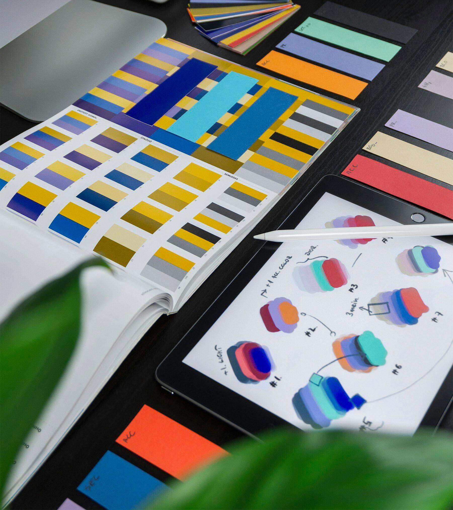 色見本とタブレットのスケッチを並べた制作デスク